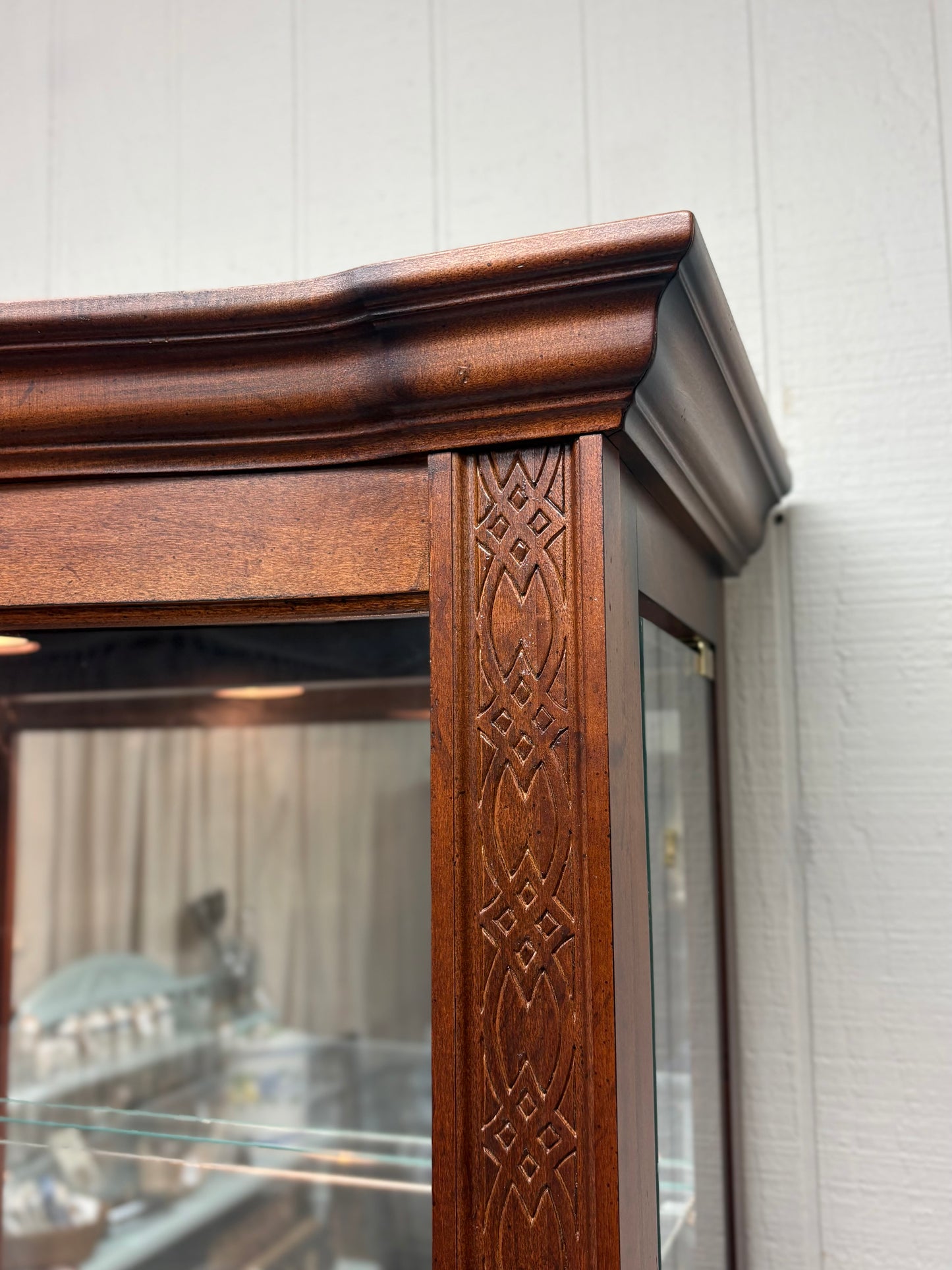 Footed Cherry Curio with Bowed Front & Carved Detail