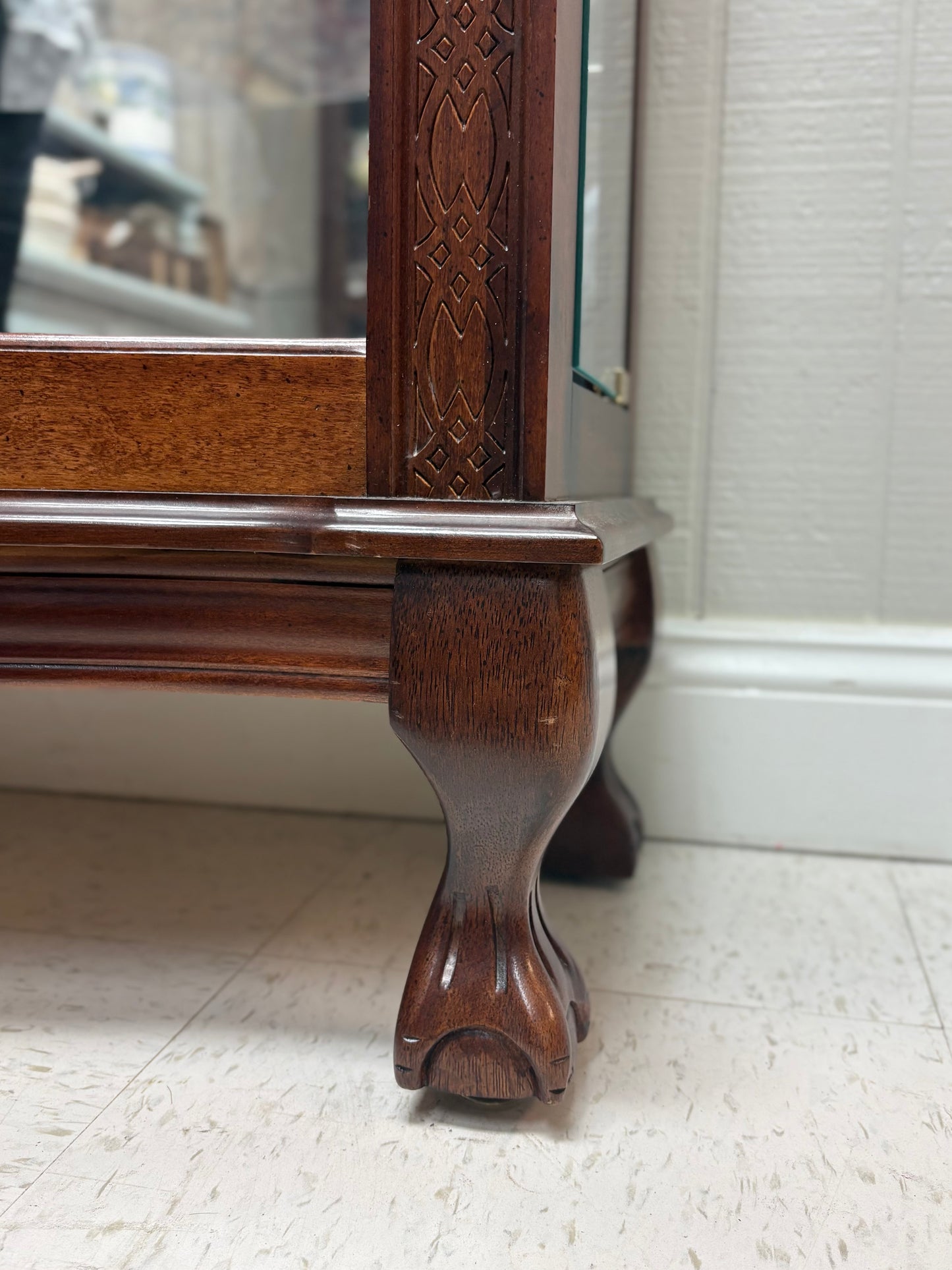 Footed Cherry Curio with Bowed Front & Carved Detail